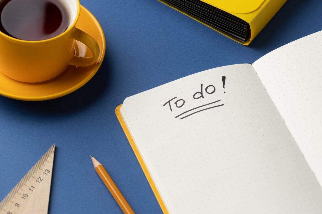 Flat lay notebook with to do list on desk
